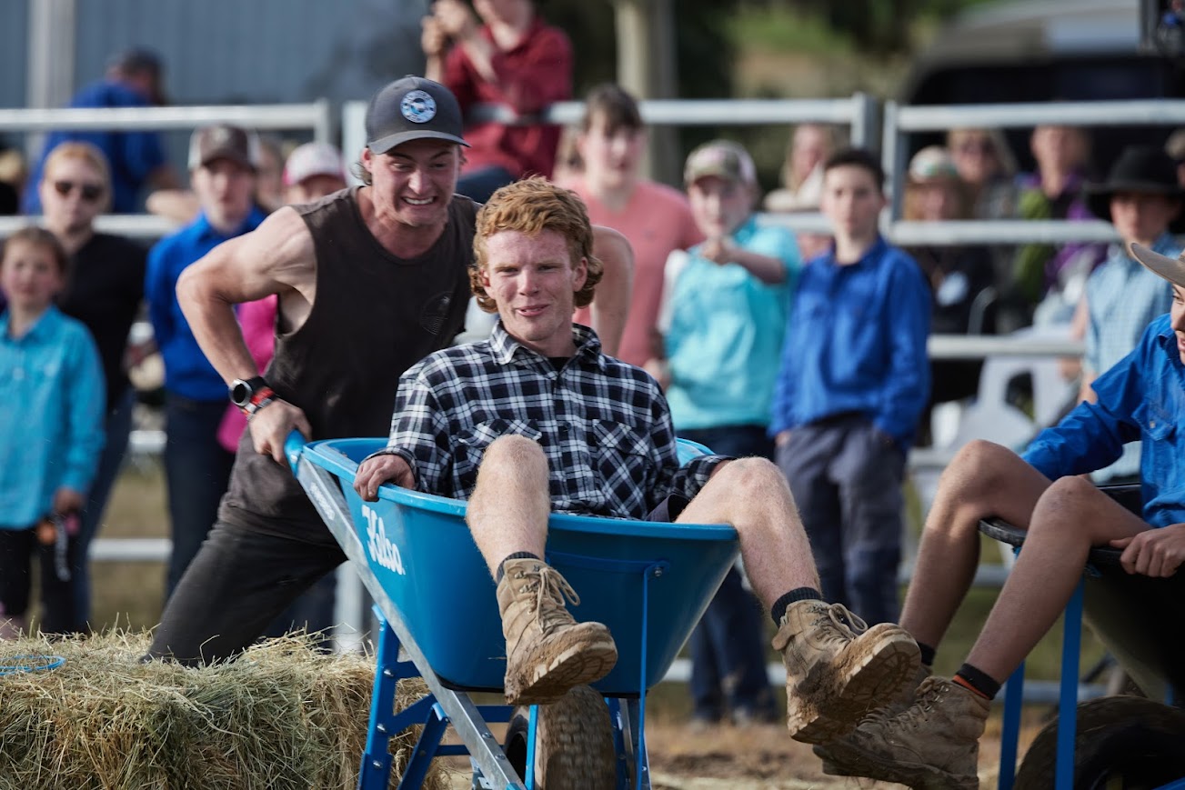 Young people participating in wheelbarrow race